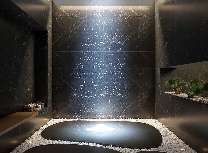 TechnoAlpin SnowSky Indoor-Schneeinstallation: dunkler moderner Spa-Raum mit Schneefall von der Decke auf Steinsockel und Kieselsteinen