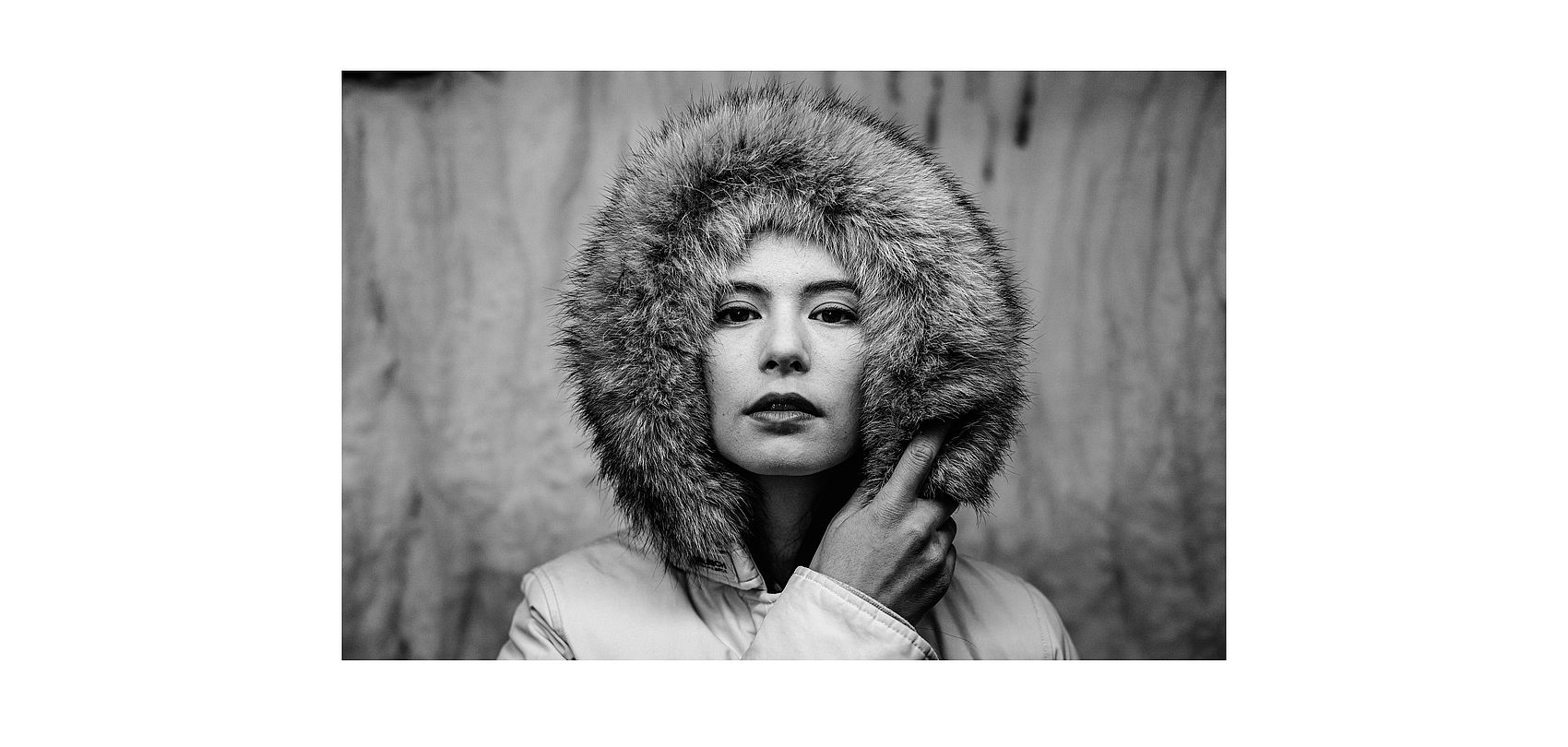 Black and white portrait of woman with fur-trimmed hood of winter jacket