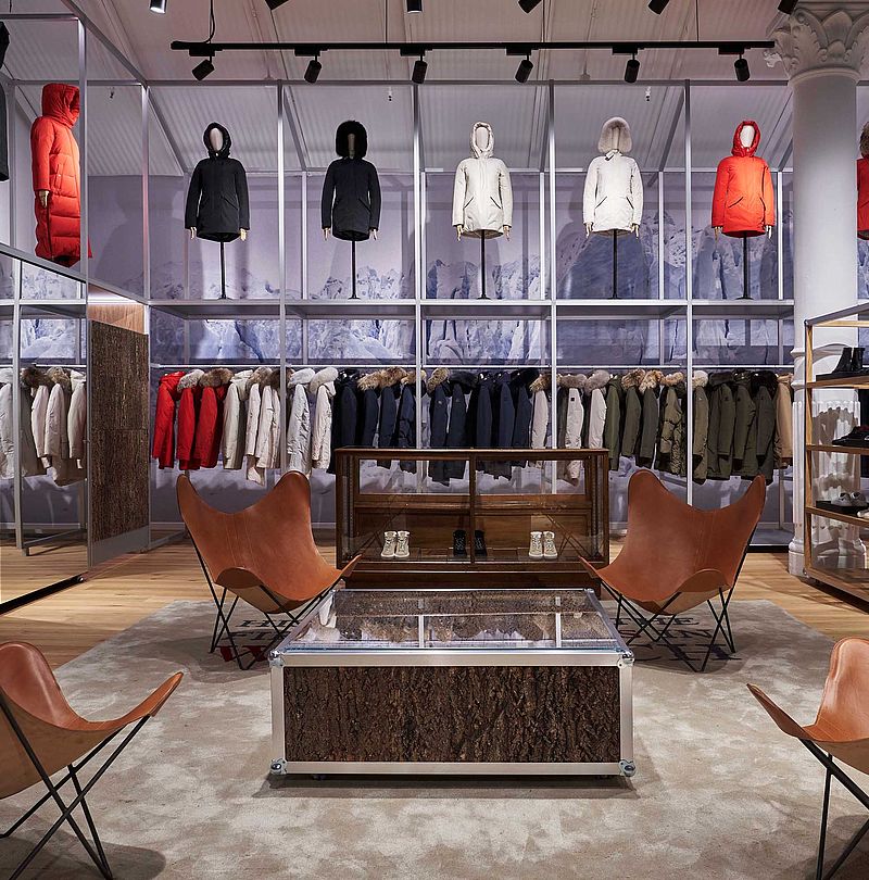 Woolrich store with parka collection, floating mannequins and butterfly leather armchairs