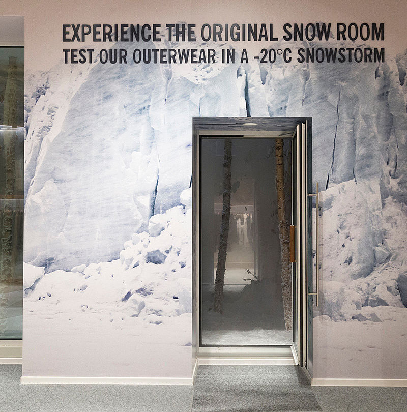 Entrance to Woolrich SnowRoom with glacier wall graphic and inscription Experience the Original Snow Room